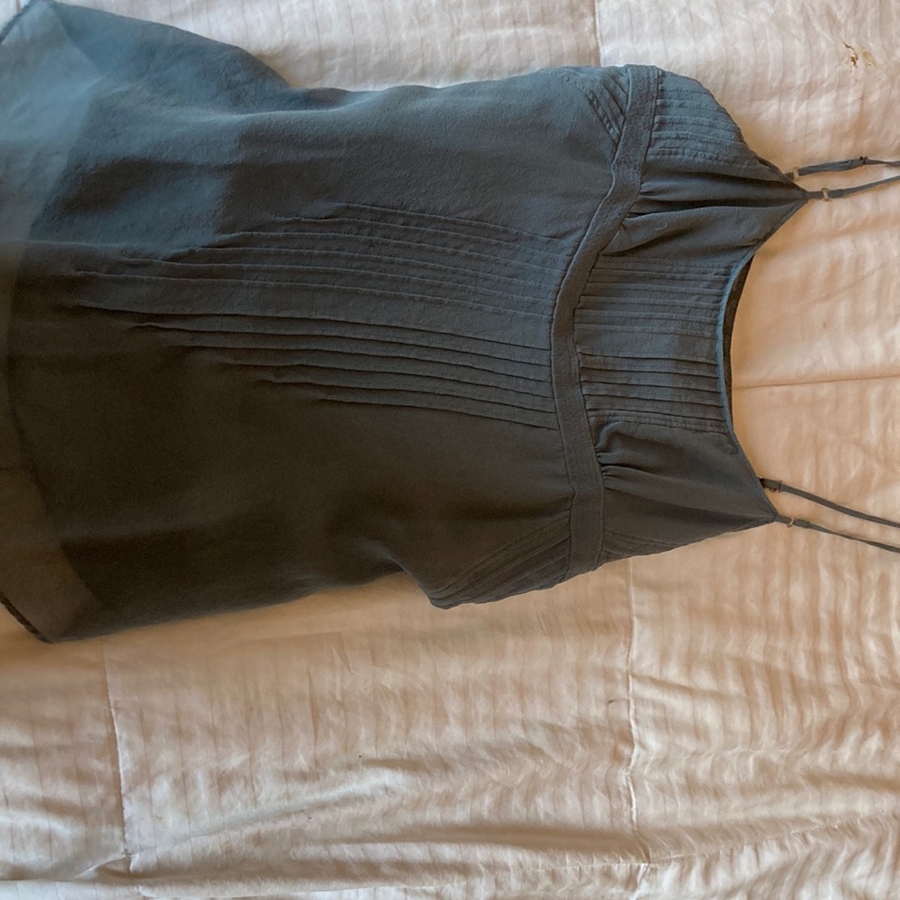 Grayish blue top with real shell buttons at the sides. 100% silk.